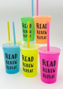 color-changing plastic cups with straws in a variety of vibrant colors with the words "Read, Renew, Repeat" on the side of each cup