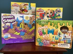 Prize bundle with Play-Doh Drill n’ Fill Dentist, Play-Doh Care & Carry Vet, Kinetic Sand, and a Jumbo Slime Kit
