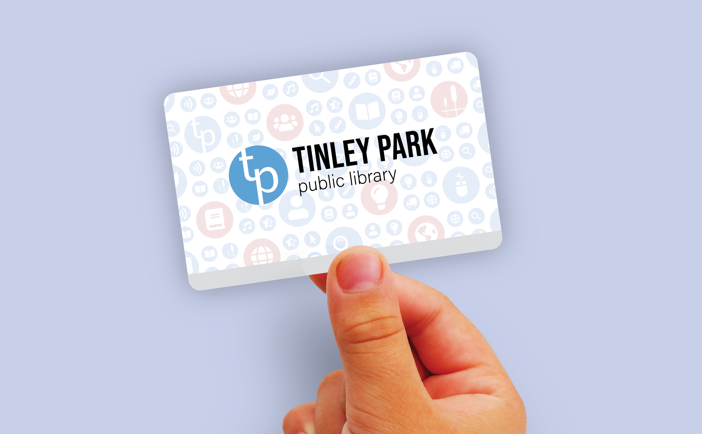 A hand holding a Tinley Park Public Library card