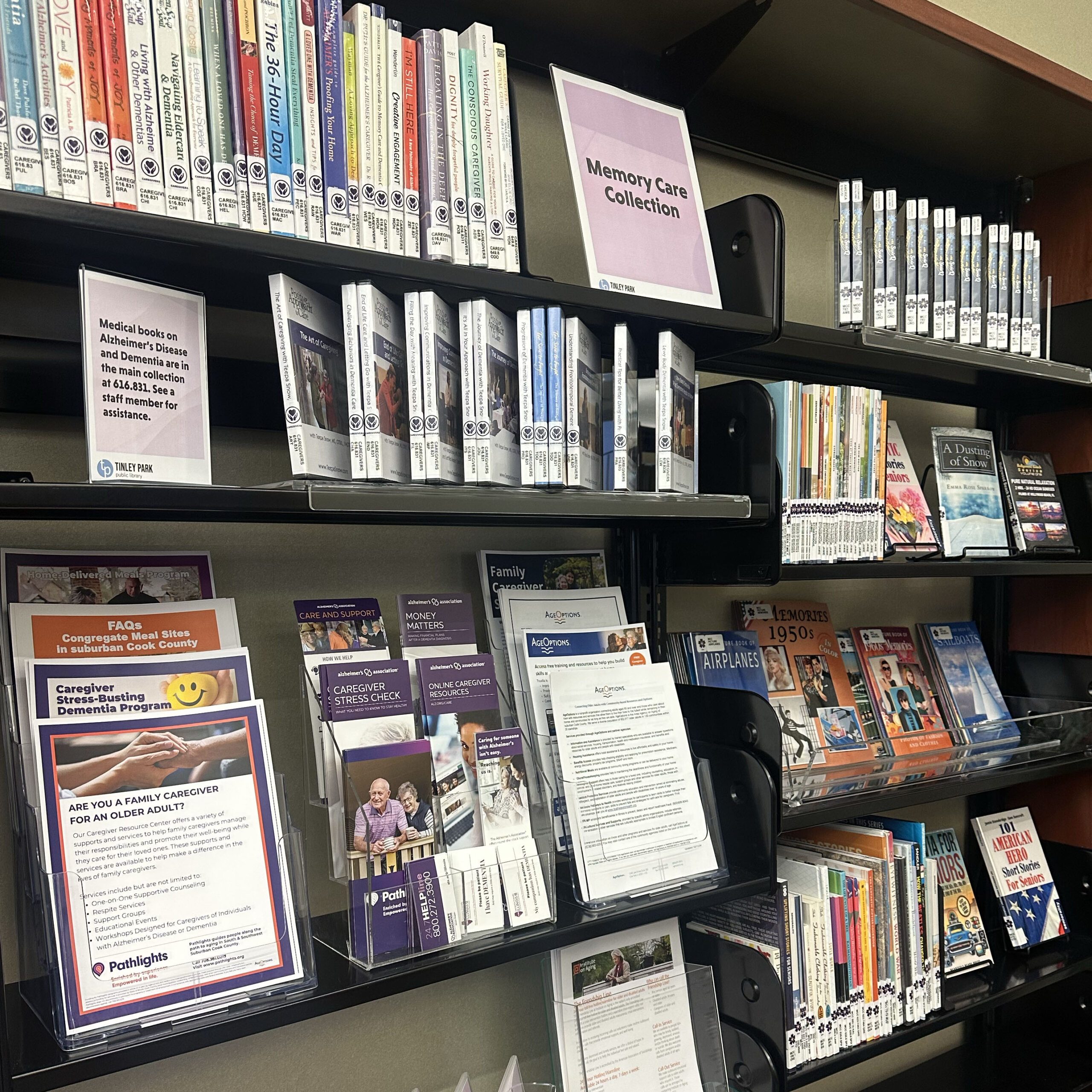 Memory Care Collection shelves full of books, DVDs, and pamphlets